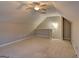 Bonus room area with sloped ceilings, railing and carpeting at 227 Lantana Dr, Locust Grove, GA 30248