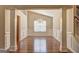 Bright dining room features hardwood floors, modern chandelier, wainscoting, and natural light from window at 227 Lantana Dr, Locust Grove, GA 30248