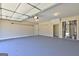 Spacious garage featuring a clean epoxy floor, ample storage, and overhead lighting for a functional space at 227 Lantana Dr, Locust Grove, GA 30248