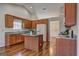 Well-equipped kitchen with wood cabinets, granite countertops, and an island, ideal for cooking and dining at 227 Lantana Dr, Locust Grove, GA 30248
