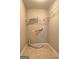 A functional laundry room with tile flooring, dryer hookups and basic shelving at 227 Lantana Dr, Locust Grove, GA 30248