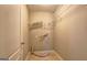 A basic laundry room with tile flooring, shelving, and dryer hookups at 227 Lantana Dr, Locust Grove, GA 30248