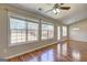 Living room with hardwood floors, ceiling fan, recessed lighting and natural light from three large windows at 227 Lantana Dr, Locust Grove, GA 30248