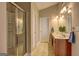 Bright bathroom featuring a glass enclosed shower, double sink vanity and tile floors at 227 Lantana Dr, Locust Grove, GA 30248