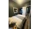 Cozy bedroom featuring dark walls and modern wood look floors; a bed and mounted tv completes the interior at 1528 Olympian Sw Way, Atlanta, GA 30310