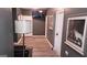 Hallway with dark gray walls, wood-look floors, and a mounted TV, decorated with artwork for a modern, inviting feel at 1528 Olympian Sw Way, Atlanta, GA 30310