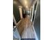 Well-lit hallway with dark gray walls and modern flooring, featuring multiple doors leading to various rooms at 1528 Olympian Sw Way, Atlanta, GA 30310