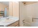 Bathroom featuring a shower and bathtub combination next to a single sink and vanity at 627 Radford Cir, Woodstock, GA 30188