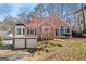 Charming split-level home with a two-car garage, brick accents, and well-maintained landscaping on a sunny day at 627 Radford Cir, Woodstock, GA 30188