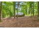 Spacious backyard with mature trees providing ample shade and privacy from a wood fence at 105 Oak Leaf Ct, Fayetteville, GA 30214