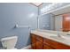 Bathroom with wooden vanity, granite countertop, and a large mirror at 105 Oak Leaf Ct, Fayetteville, GA 30214