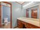 Bathroom with wooden vanity, granite countertop and large mirror at 105 Oak Leaf Ct, Fayetteville, GA 30214