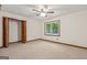 Bedroom with a double door closet, carpet, and a window with a view of the lush backyard at 105 Oak Leaf Ct, Fayetteville, GA 30214