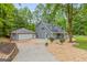 Exterior view of home with detached garage and well-maintained landscaping at 105 Oak Leaf Ct, Fayetteville, GA 30214