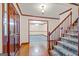 Inviting foyer featuring hardwood floors, wooden trim and staircase at 105 Oak Leaf Ct, Fayetteville, GA 30214