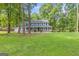 Charming two-story home with a welcoming front porch and lush green lawn at 105 Oak Leaf Ct, Fayetteville, GA 30214