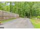 Backyard parking pad with wooden fence, ideal for guest parking or recreational vehicle at 105 Oak Leaf Ct, Fayetteville, GA 30214