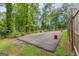 Backyard parking pad beside a grassy area, and wooden fence at 105 Oak Leaf Ct, Fayetteville, GA 30214