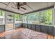 Enclosed sunroom features tile floor, ceiling fan, hot tub, and a view of the backyard pool at 105 Oak Leaf Ct, Fayetteville, GA 30214