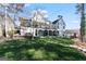 Expansive backyard featuring a covered patio and lush greenery at 4185 Etcetera Ln, Cumming, GA 30041