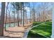 Spacious backyard featuring a lake view and a lush green lawn at 4185 Etcetera Ln, Cumming, GA 30041