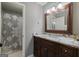 Elegant bathroom featuring granite counters, decorative vanity, a shower with a patterned curtain at 4185 Etcetera Ln, Cumming, GA 30041