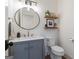 Stylish powder room with vanity, decorative mirror and marble countertop at 4185 Etcetera Ln, Cumming, GA 30041