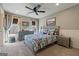 A bedroom with a bed, a ceiling fan, two dressers and a window seating area at 4185 Etcetera Ln, Cumming, GA 30041