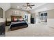 Spacious bedroom featuring neutral paint, carpet, a ceiling fan, and a built-in window seat at 4185 Etcetera Ln, Cumming, GA 30041