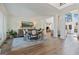 Elegant dining area features wood floors, columns, and transitions seamlessly to a living space at 4185 Etcetera Ln, Cumming, GA 30041