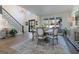 Bright dining room boasts a round table, white chairs, hardwood floors, and staircase, creating a sophisticated and inviting atmosphere at 4185 Etcetera Ln, Cumming, GA 30041