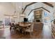 Bright dining room with exposed wood beams, stone fireplace, wood floors, and view to the living room at 4185 Etcetera Ln, Cumming, GA 30041