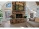 Stone fireplace with mantle in living room featuring wood floors, many windows, and lots of natural light at 4185 Etcetera Ln, Cumming, GA 30041