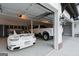 Well-organized garage featuring multiple vehicles, storage cabinets, and overhead lighting at 4185 Etcetera Ln, Cumming, GA 30041