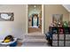 Hallway with carpeted steps leading to a playroom, showcasing decor and storage solutions at 4185 Etcetera Ln, Cumming, GA 30041