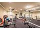 A full home gym featuring weightlifting equipment, a mirrored wall, and rubber flooring at 4185 Etcetera Ln, Cumming, GA 30041