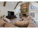 Inviting living room enhanced by a stone fireplace, built-in media center, and vaulted ceilings at 4185 Etcetera Ln, Cumming, GA 30041