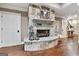 Cozy living room with a stone fireplace, hardwood floors, and neutral paint at 4185 Etcetera Ln, Cumming, GA 30041