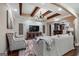 Cozy living room featuring beamed ceilings, plush seating, and a bar area for entertaining guests at 4185 Etcetera Ln, Cumming, GA 30041