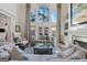 Living room with high ceilings, fireplace, built-in shelves, and french doors to back patio at 4185 Etcetera Ln, Cumming, GA 30041