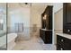 Well-lit main bathroom featuring dual vanities, marble tile, and a luxurious soaking tub at 4185 Etcetera Ln, Cumming, GA 30041