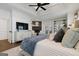 Comfortable main bedroom featuring a stone fireplace, ceiling fan, and access to a balcony at 4185 Etcetera Ln, Cumming, GA 30041