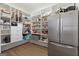 Spacious pantry with stainless steel refrigerator and lots of shelving at 4185 Etcetera Ln, Cumming, GA 30041