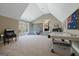 Upstairs playroom with vaulted ceiling, an arcade game, an air hockey table, and carpeted floors at 4185 Etcetera Ln, Cumming, GA 30041