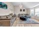 Bright living room featuring two sofas, a modern light fixture, and large windows at 4439 Persian Ct, Snellville, GA 30039