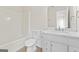 Bathroom featuring a marble vanity, white cabinets, and a tub and shower combination at 309 Coral Cir, Mcdonough, GA 30253