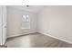 Bedroom features hardwood floors, neutral paint, and a large window at 309 Coral Cir, Mcdonough, GA 30253