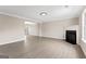 Open-concept living room with wood floors and a fireplace at 309 Coral Cir, Mcdonough, GA 30253