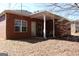 Back of the brick home featuring a covered patio area perfect for outdoor seating and relaxation at 128 Astilbe Meadow Dr, Locust Grove, GA 30248