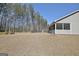 View of the backyard and screen porch, fenced in, on a sunny day at 625 Timberbrook Dr, Sharpsburg, GA 30277